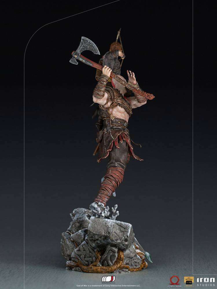 Side view of Iron Studios 1/10 Kratos & Atreus statue, featuring detailed armor and axe on a rocky display base.