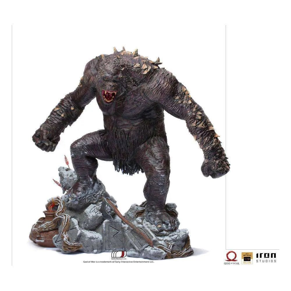 Iron Studios God of War Ogre 1/10 scale statue in a dynamic pose on a rocky base with detailed dark skin and spikes.