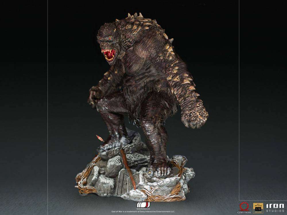 Iron Studios God of War Ogre 1/10 scale statue in a side view, featuring a textured, dark monster on a rocky base.