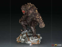 Iron Studios God of War Ogre 1/10 scale statue in a side view, featuring a textured, dark monster on a rocky base.