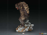 Side view of the 32 cm Iron Studios God of War Ogre statue featuring textured brown skin and rocky base details.