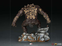 Back view of the 32 cm Iron Studios God of War Ogre statue featuring textured brown skin and bone-like armor plates.