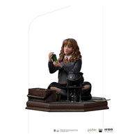 Iron Studios 1/10 Hermione Granger Polyjuice statue showing her sitting with a potion bottle and cauldron on a base.