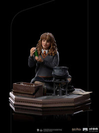 Iron Studios 1/10 scale Hermione Granger Polyjuice statue showing her with a potion vial and cauldron on a base.