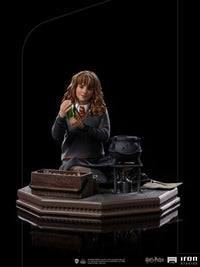 Iron Studios 1/10 Hermione Granger Polyjuice statue showing her holding a potion vial by a cauldron on a display base.