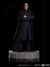 Iron Studios 1/10 Severus Snape statue in a black robe and blue coat, standing on a textured stone-style base.