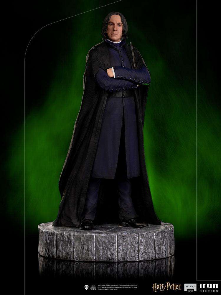 Iron Studios 1/10 scale Severus Snape statue wearing a black cloak and blue robes on a stone-textured circular base.