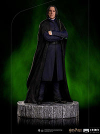Iron Studios 1/10 scale Severus Snape statue wearing a black cloak and blue robes on a stone-textured circular base.