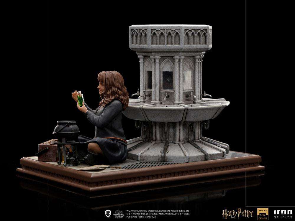 Side view of Iron Studios Hermione Granger Polyjuice 1/10 scale statue sitting by a stone fountain with a potion vial.