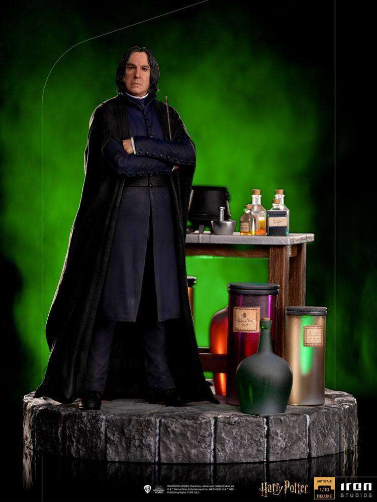 Iron Studios 1/10 Severus Snape statue standing with arms crossed, featuring a potion desk and green background.