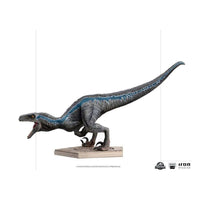 Side view of Iron Studios 1/10 Blue Jurassic World statue, featuring a textured grey raptor with a blue stripe.