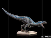 Side view of the 19cm Iron Studios Blue statue from Jurassic World, featuring textured grey skin and a blue stripe.