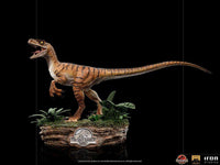 Side view of Iron Studios 1/10 scale Velociraptor statue from The Lost World on a detailed jungle base.