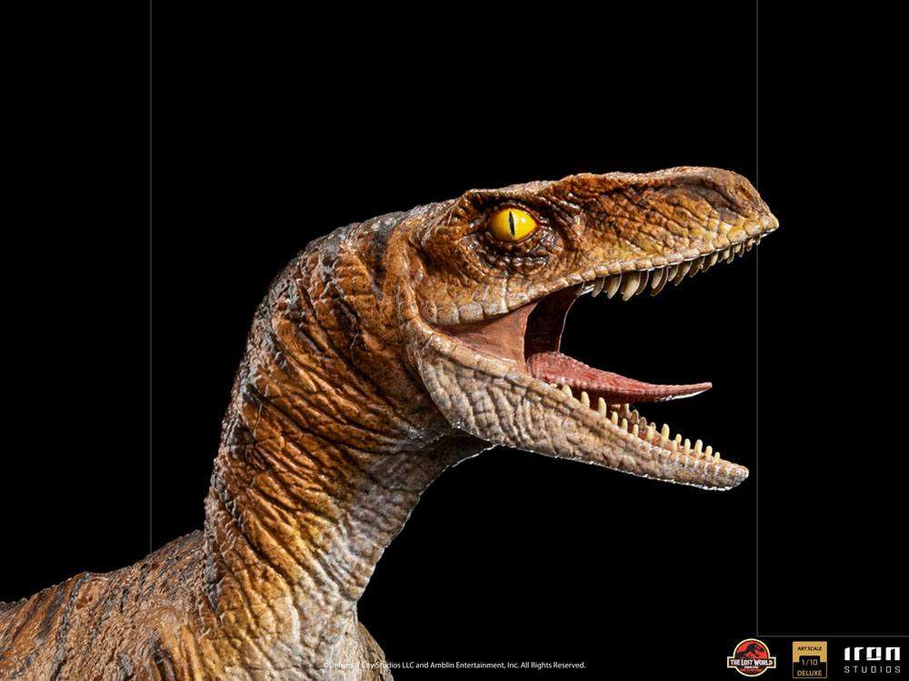 Close-up of the Iron Studios Jurassic World The Lost World 1/10 Velociraptor statue with detailed brown skin and yellow eyes.