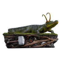Iron Studios Alligator Loki 1/10 scale statue featuring a detailed green alligator with golden horns on a root base.