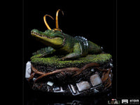Iron Studios Alligator Loki 1/10 scale statue featuring a green alligator with golden horns on a detailed swamp base.