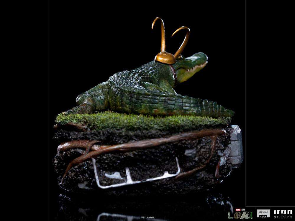Iron Studios Alligator Loki 1/10 scale statue featuring a green alligator with a gold horned helmet on a mossy base.
