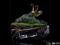 Iron Studios Alligator Loki 1/10 scale statue featuring a green alligator with a gold horned helmet on a mossy base.