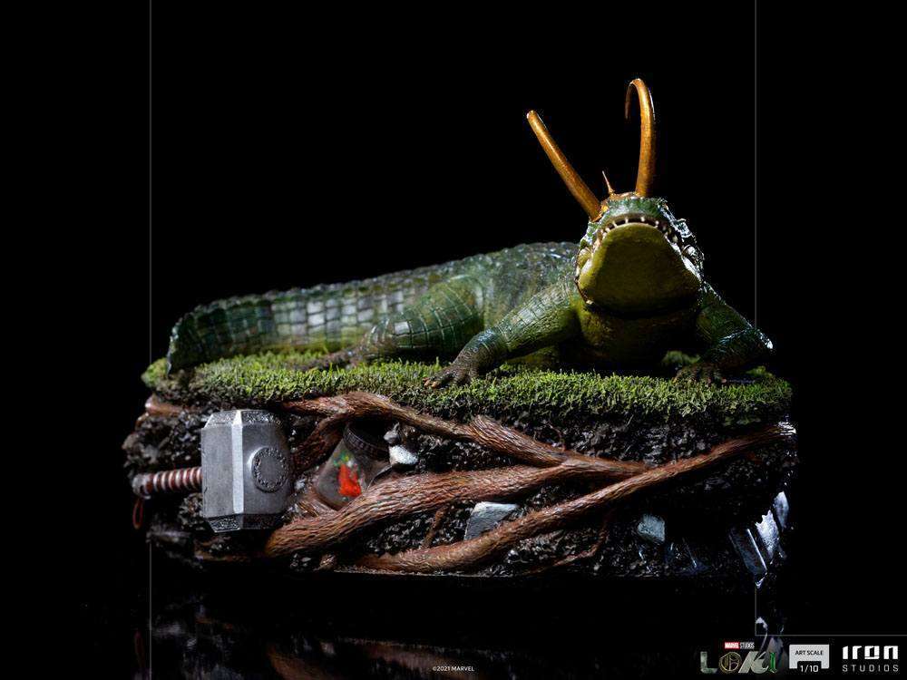 Iron Studios Alligator Loki 1/10 scale statue featuring the green reptile with golden horns on a detailed grassy base.