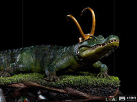 Iron Studios 1/10 scale Alligator Loki statue featuring a detailed green textured alligator wearing a gold horned helmet.