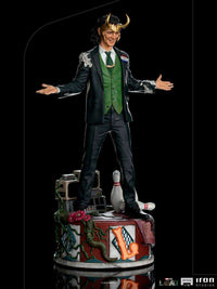 Iron Studios 1/10 Loki President Variant statue in a green vest and suit, standing on a detailed, themed display base.