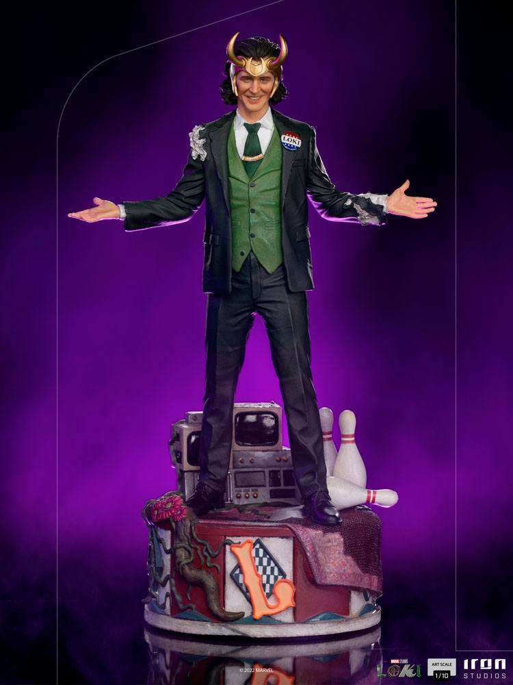 Iron Studios Loki President Variant 1/10 scale statue in a green suit with a Loki campaign pin on a themed base.