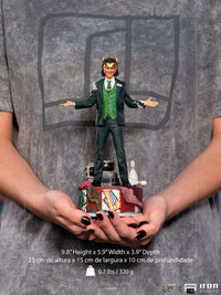 Iron Studios Loki President Variant 1/10 scale statue in a green suit with horned helmet, held in hands.