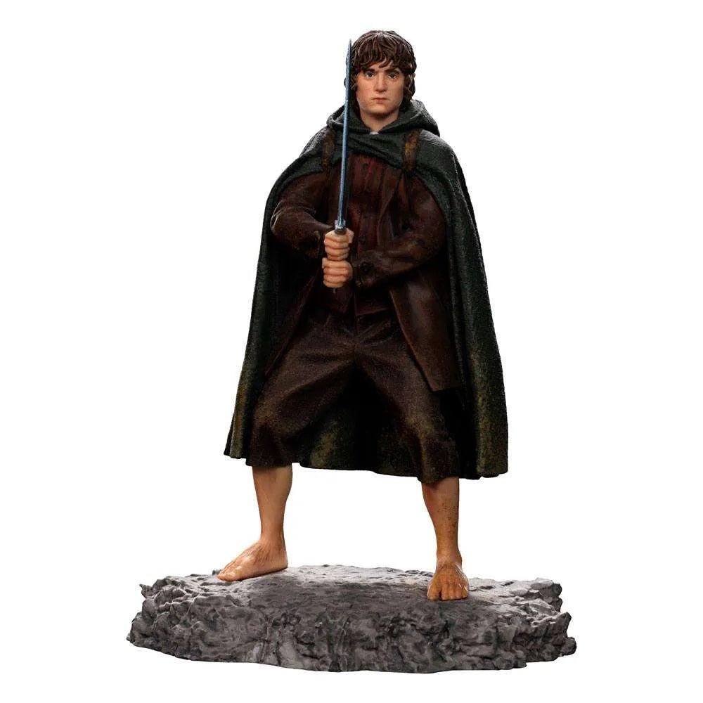 Iron Studios 1/10 scale Frodo statue showing the character in a brown outfit and green cloak holding Sting on a base.
