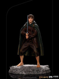 Front view of the 12cm Iron Studios Frodo BDS Art Scale statue holding Sting on a rocky base.