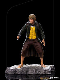 Iron Studios 1/10 scale Merry statue from Lord of the Rings, featuring the hobbit holding a sword on a rocky base.