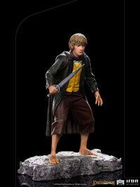 Iron Studios 1/10 scale Merry statue from Lord of the Rings, featuring the hobbit holding a sword on a rocky base.