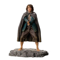 Front view of Iron Studios 1/10 Pippin statue, featuring the hobbit in a cloak holding a sword on a rocky base.