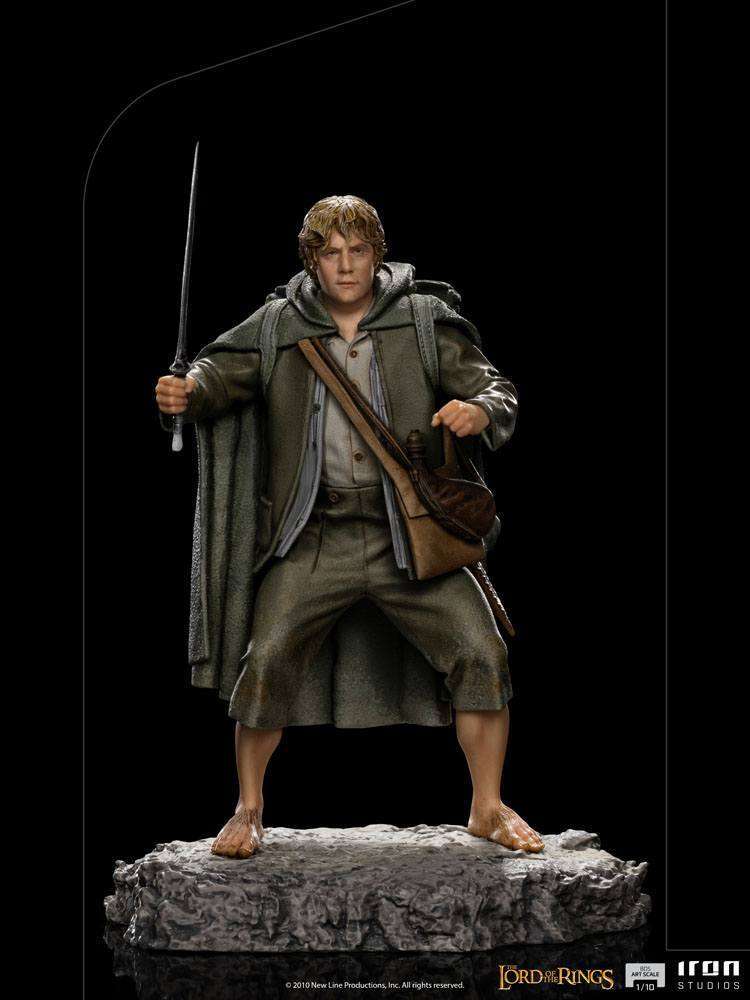 Front view of Iron Studios Sam 1/10 scale statue, featuring the hobbit in a green cloak holding a sword on a rocky base.