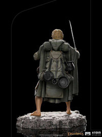 Rear view of Iron Studios Sam 1/10 scale statue, featuring detailed travel gear, cooking pans, and cloak on a rock base.