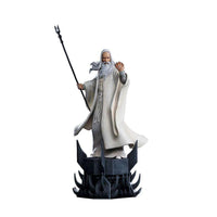 Iron Studios Saruman 1/10 scale statue in white robes holding a staff on a dark, spiked Orthanc-themed base.