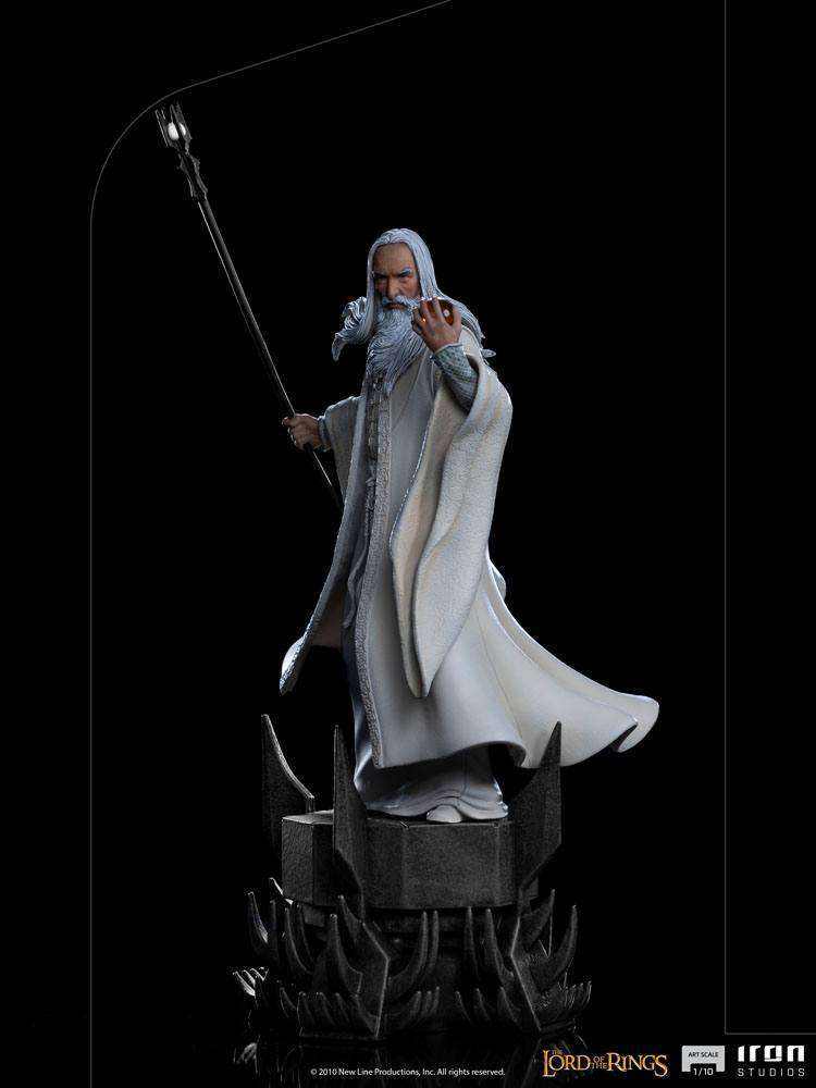 Iron Studios 1/10 scale Saruman statue from Lord of the Rings, featuring the wizard in white robes holding a staff.