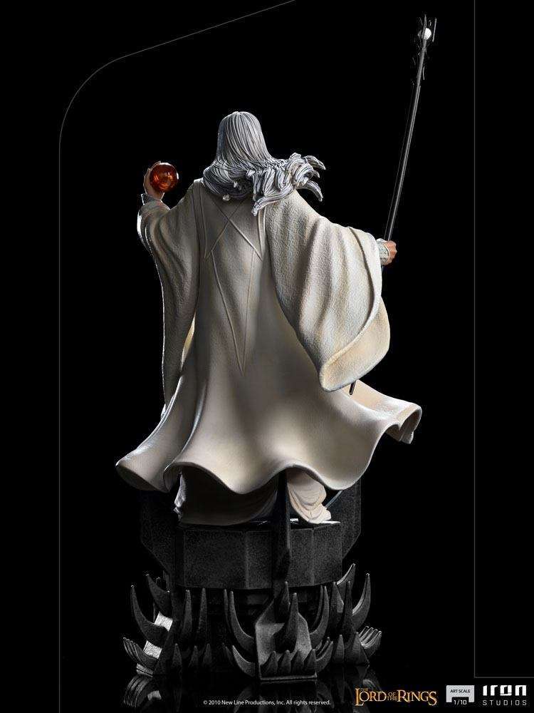 Back view of the 29 cm Iron Studios Saruman 1/10 scale statue wearing white robes, holding a staff and glowing orb.