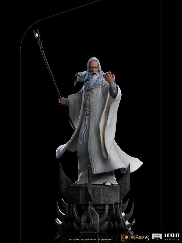 Iron Studios 1/10 Saruman statue from Lord of the Rings, featuring the wizard in white robes holding a staff on a base.