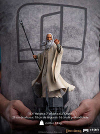 Iron Studios 1/10 scale Saruman statue from Lord of the Rings, featuring the wizard holding a staff on a dark base.
