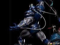 Side view of the Iron Studios 1/10 Apocalypse Deluxe statue featuring blue metallic armor and intricate cable details.