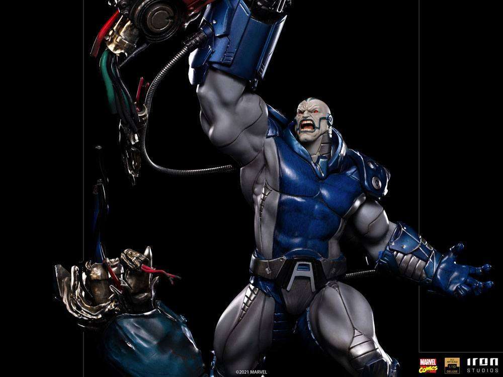 Iron Studios Apocalypse Deluxe 1/10 scale statue in blue and grey armor, featuring a dynamic pose on a black background.