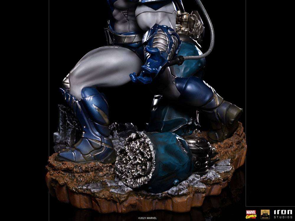 Side view of the Iron Studios Apocalypse 1/10 scale statue featuring metallic blue armor and a rocky debris base.