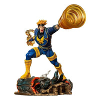 Iron Studios Havok 1/10 scale statue in blue and yellow suit, firing translucent energy effects from his hands.