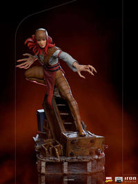 Iron Studios 1/10 Lady Deathstrike statue featuring red hair, brown armor, and long claws on a wooden base, front view.