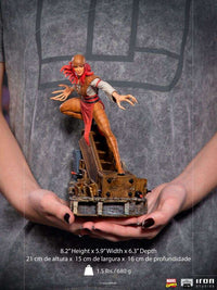 Iron Studios Lady Deathstrike 1/10 scale statue with red hair and long claws, held in hands, front view.
