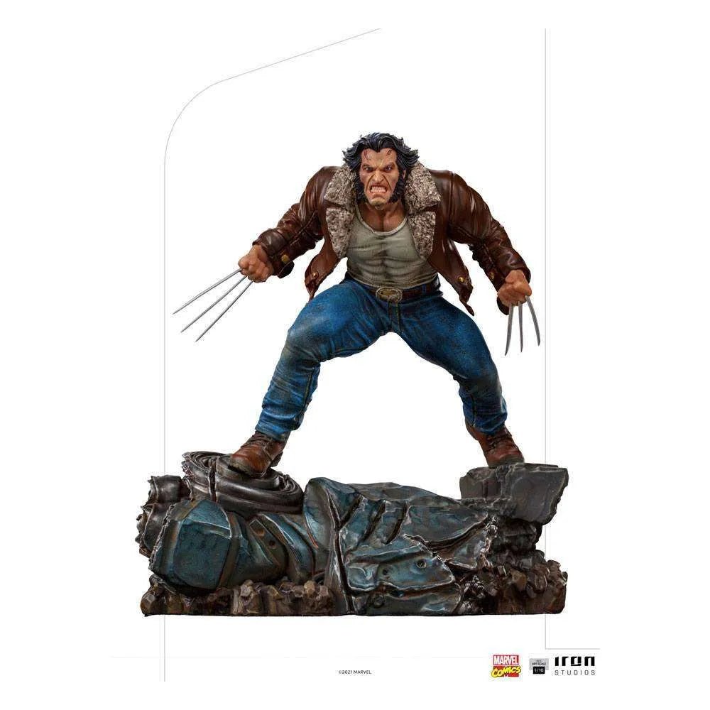 Iron Studios 1/10 Logan statue showing Wolverine in a brown leather jacket and blue jeans standing on a debris base.
