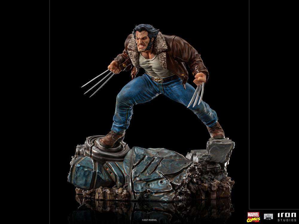 Iron Studios 1/10 Logan statue showing Wolverine in a brown leather jacket and jeans with claws extended on a base.