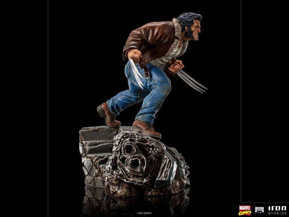 Side view of Iron Studios 1/10 Logan statue wearing a brown leather jacket and jeans with extended metal claws.