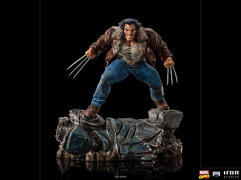 Iron Studios 1/10 Logan statue showing Wolverine in a brown leather jacket and blue jeans with claws extended on a base.