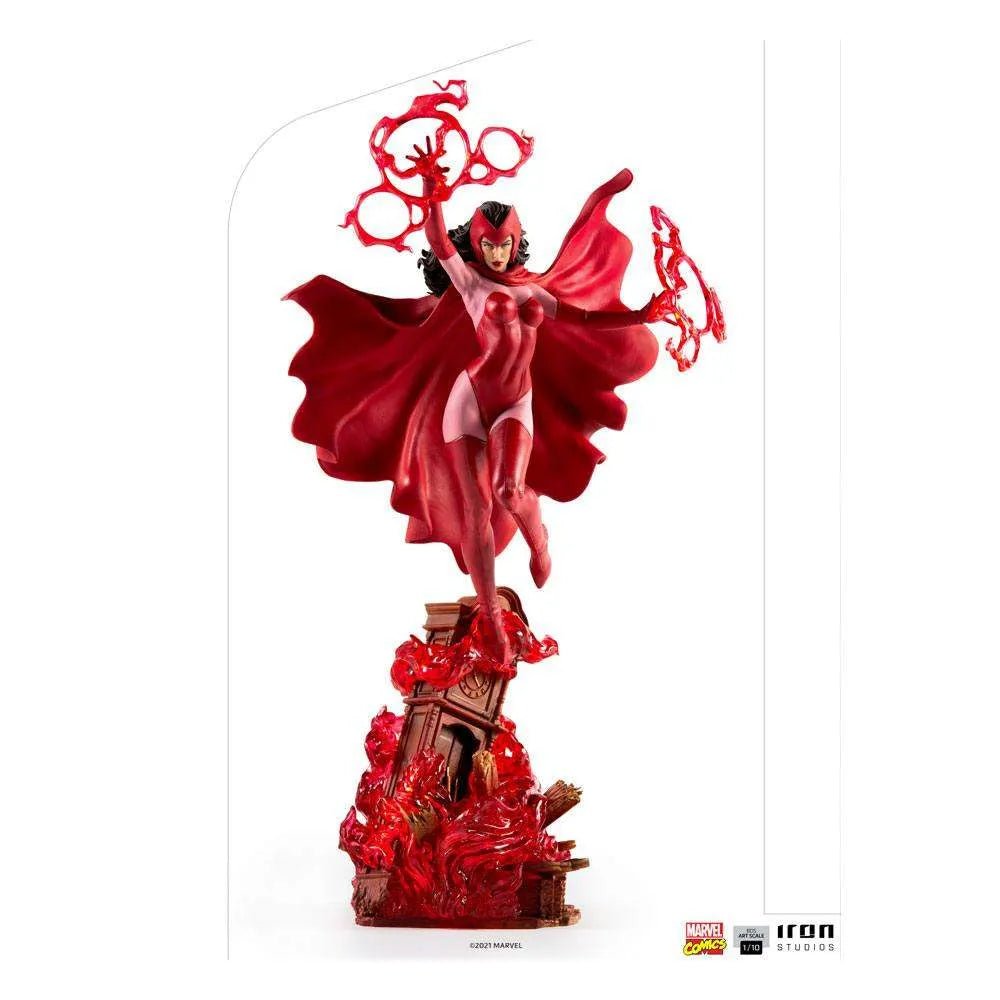 Iron Studios 1/10 Scarlet Witch statue in a red costume, floating above a ruined clock tower with magical energy effects.